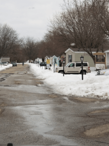 A mobile home park with snow on the ground