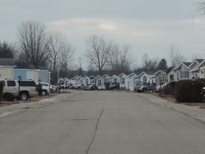 A large mobile home park with a paved road
