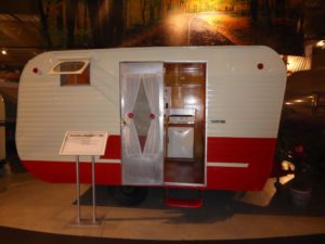A small red mobile home from the 40's