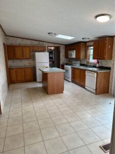 a mobile home kitchen that has a white floor