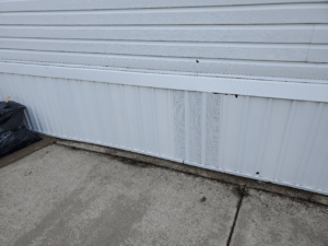 White vinyl skirting on a mobile home up close