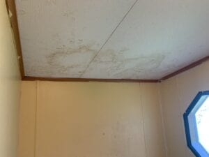 A water stain leak on a ceiling in a mobile home