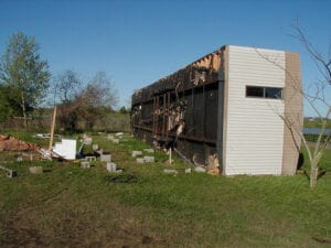 A singlewide mobile home flipped over