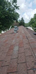 A 3 in 1 shingle roof with spots on it from hail