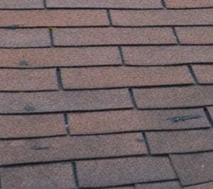 A close up of a hail damage roof