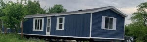 A mobile home with new blue siding