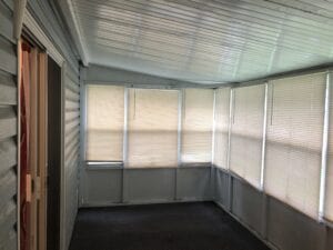 The inside of a screen in porch on a mobile home