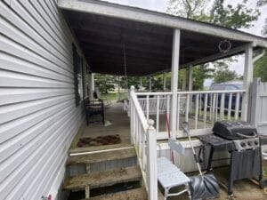 A covered deck attached to a doublewide mobile home