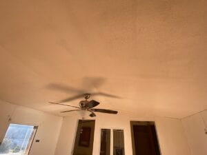 A ceiling in a mobile home with a crack