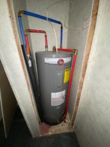 a hot water heater with a mobile home water shutoff valve on top of it