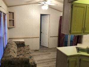 The living room area of a tiny house with brown floor