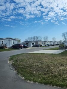 a paved road in a mobile home park with homes