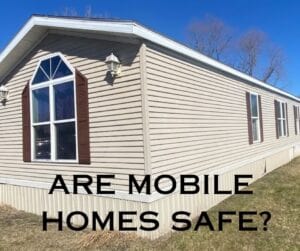 A singlewide mobile with wording saying are mobile homes safe
