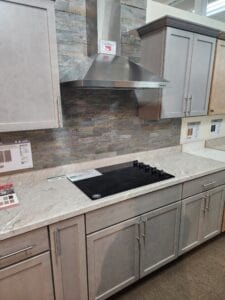 A gray kitchen with a flat stove top