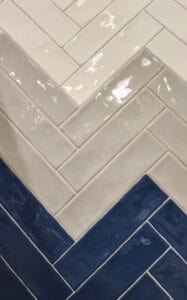 A gray white and blue herringbone style tile