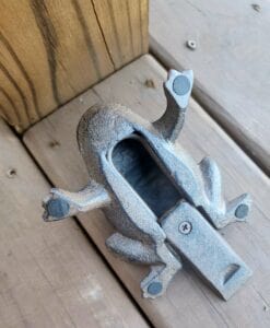 A cast iron frog flipped upside down to show a key area