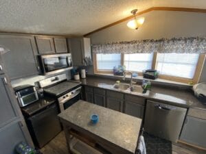 A gray kitchen cabinet in a mobile home