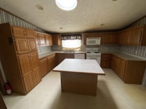 A large kitchen with cupboards down both sides