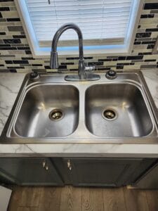 A double stainless steel sink built into a counter top