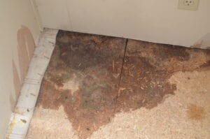 A subfloor corner with wet stains