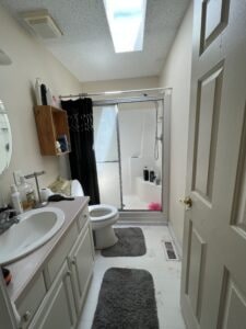 A bathroom with a skylight and rugs on the floor