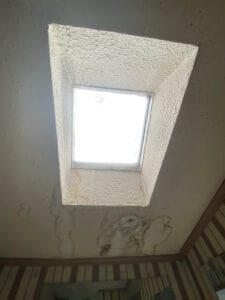 A skylight with water damage around it