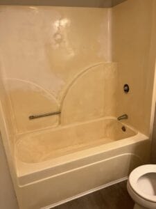 A badly stained tub and shower