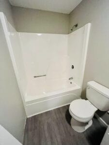 A new white shower and toilet in a bathroom