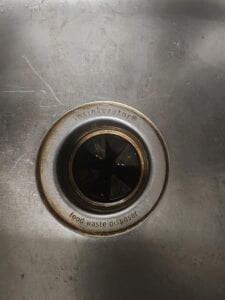 A stainless steel sink garbage disposal in a mobile home