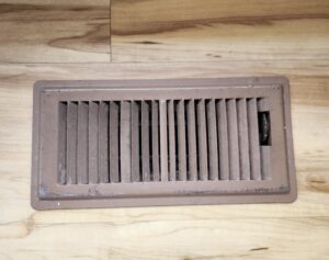 A small brown floor vent