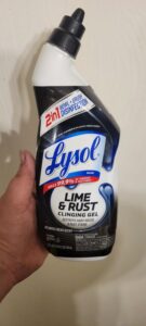 A bottle of Lysol lime & rust used to remove stains from a shower