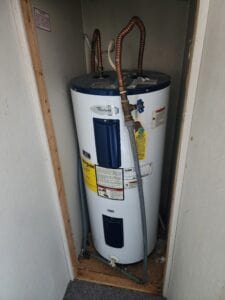 A hot water heater in a closet