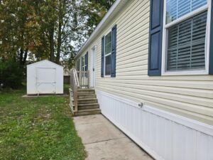 A newly sided mobile home with new deck