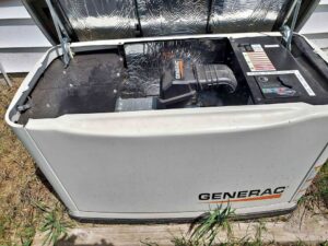 A large generac generator with the lid open