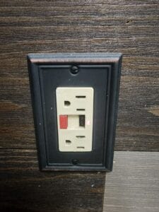 A ground fault electric outlet with a cover