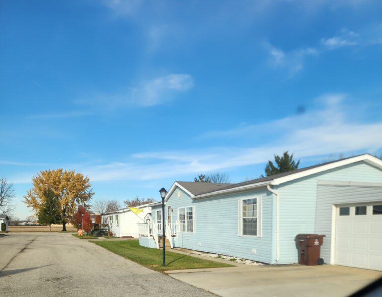 A blue doublewide in a large mobile home park