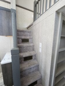 A stairway inside a double story tiny home