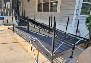 A large metal wheelchair ramp up to a home