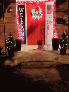 A red steel door with Christmas decorations