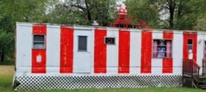 A mobile home painted like a candy cane