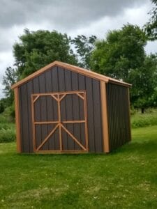 A brown shed with orange trim