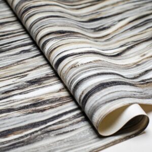 A roll of vinyl wall paper with gray and black stripes