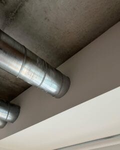 Ductwork running under a foundation into a wall