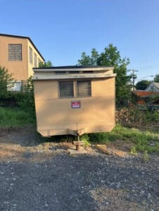 A very small trailer with a for sale sign on it