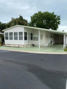 A mobile home in florida with a carport attached