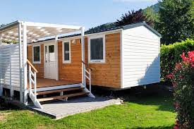 A small mobile home with wood siding
