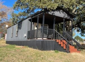 A gray colored small mini mobile home