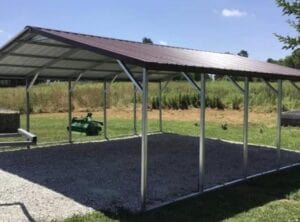 A carport that is metal with gravel floor