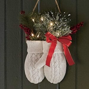 A pair of white mittens with christmas lights