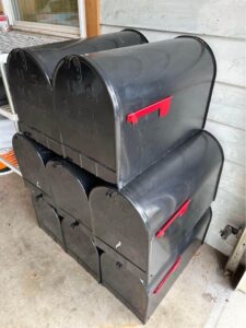 A group of black mailboxes stacked up
